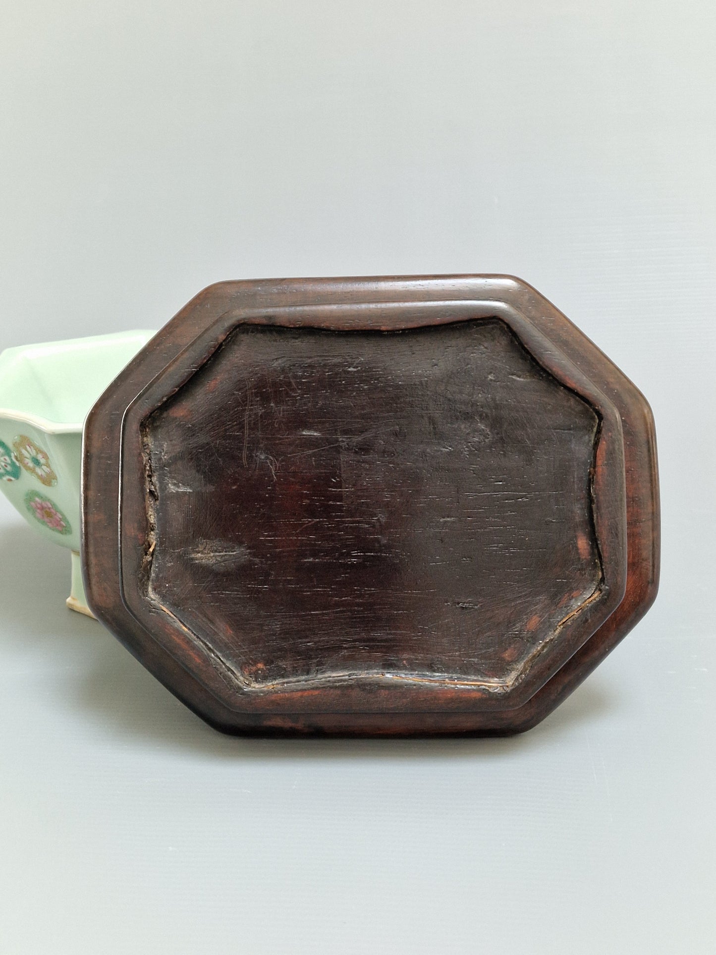 A Chinese octagonal famille rose celadon-ground 'Brocade Balls' offering bowl on a wooden stand, bearing a Daoguang mark, 19th century