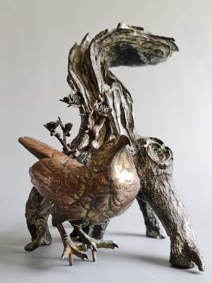 A large Japanese falcon perched on a branch, bronze sculpture, Meiji period (1868-1912)