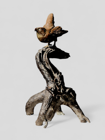 A Japanese bronze falcon perched on a branch — Meiji period (1868–1912)