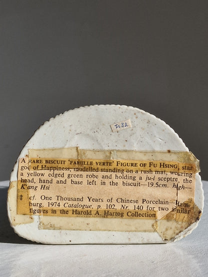 A Chinese sancai-glazed biscuit figure of a Luohan holding a ruyi — Kangxi period (1662–1722)