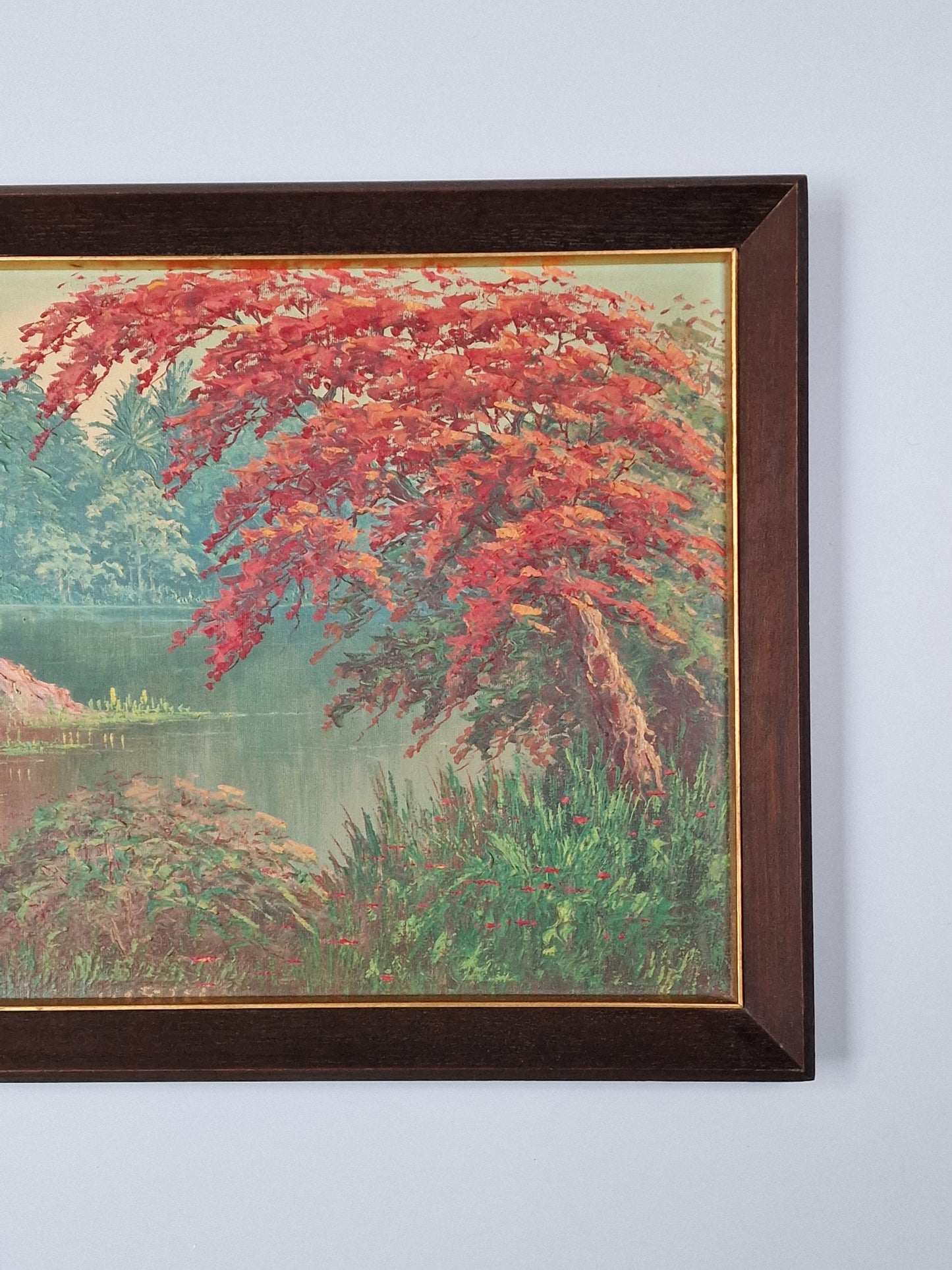 A Tropical river landscape oil painting with stilted house and a flame tree — mid-20th century