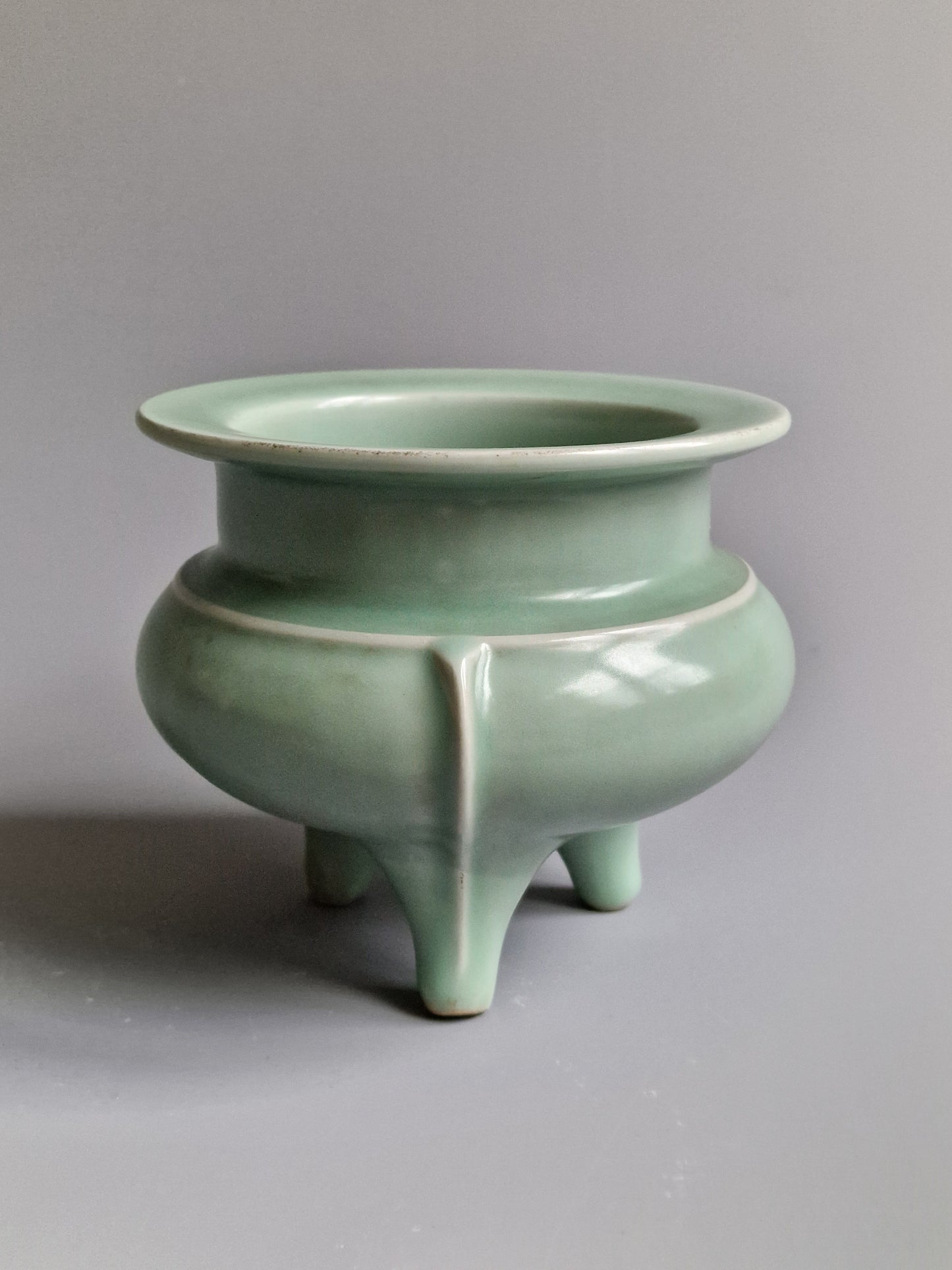 A Chinese Longquan celadon tripod censer