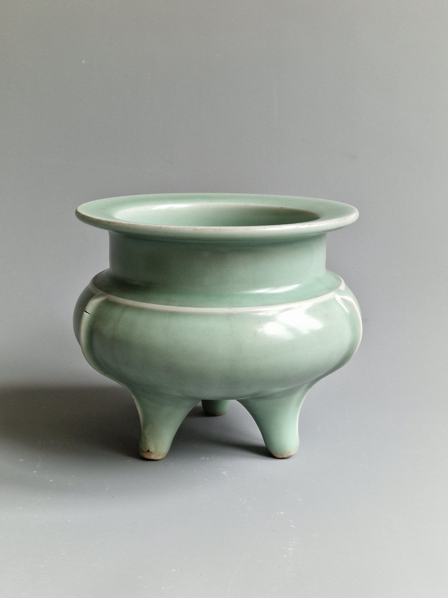 A Chinese Longquan celadon tripod censer