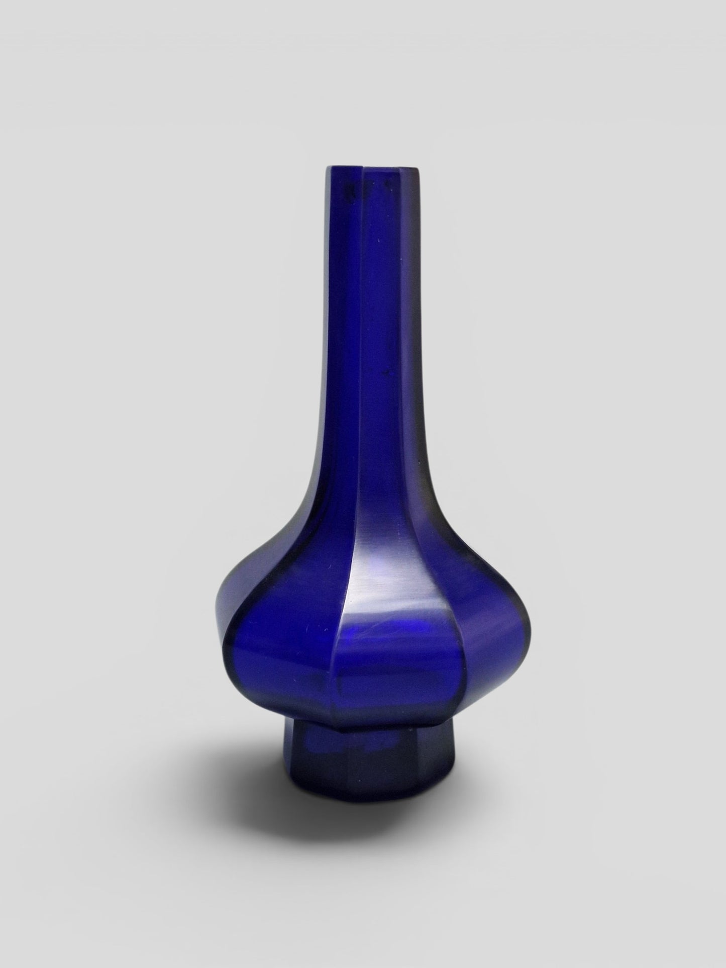 A Chinese blue Beijing glass octagonal bottle vase, Qianlong mark, with an Emery & Cie, Paris label — Republic period (1912–1949)