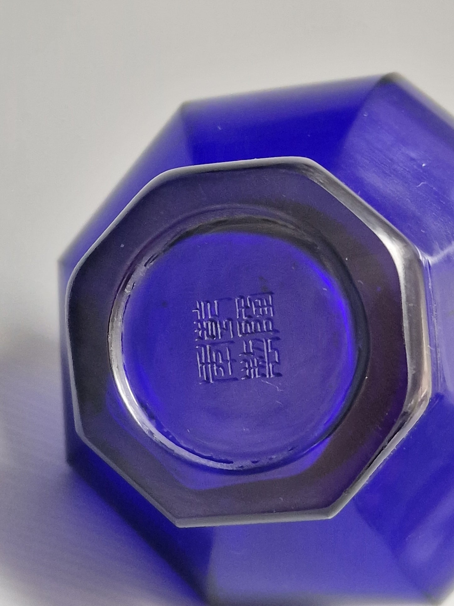 A Chinese blue Beijing glass octagonal bottle vase, Qianlong mark, with an Emery & Cie, Paris label — Republic period (1912–1949)