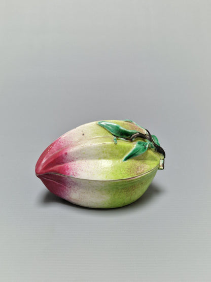 A Chinese famille rose porcelain peach-form covered box — Qing Dynasty, 19th Century