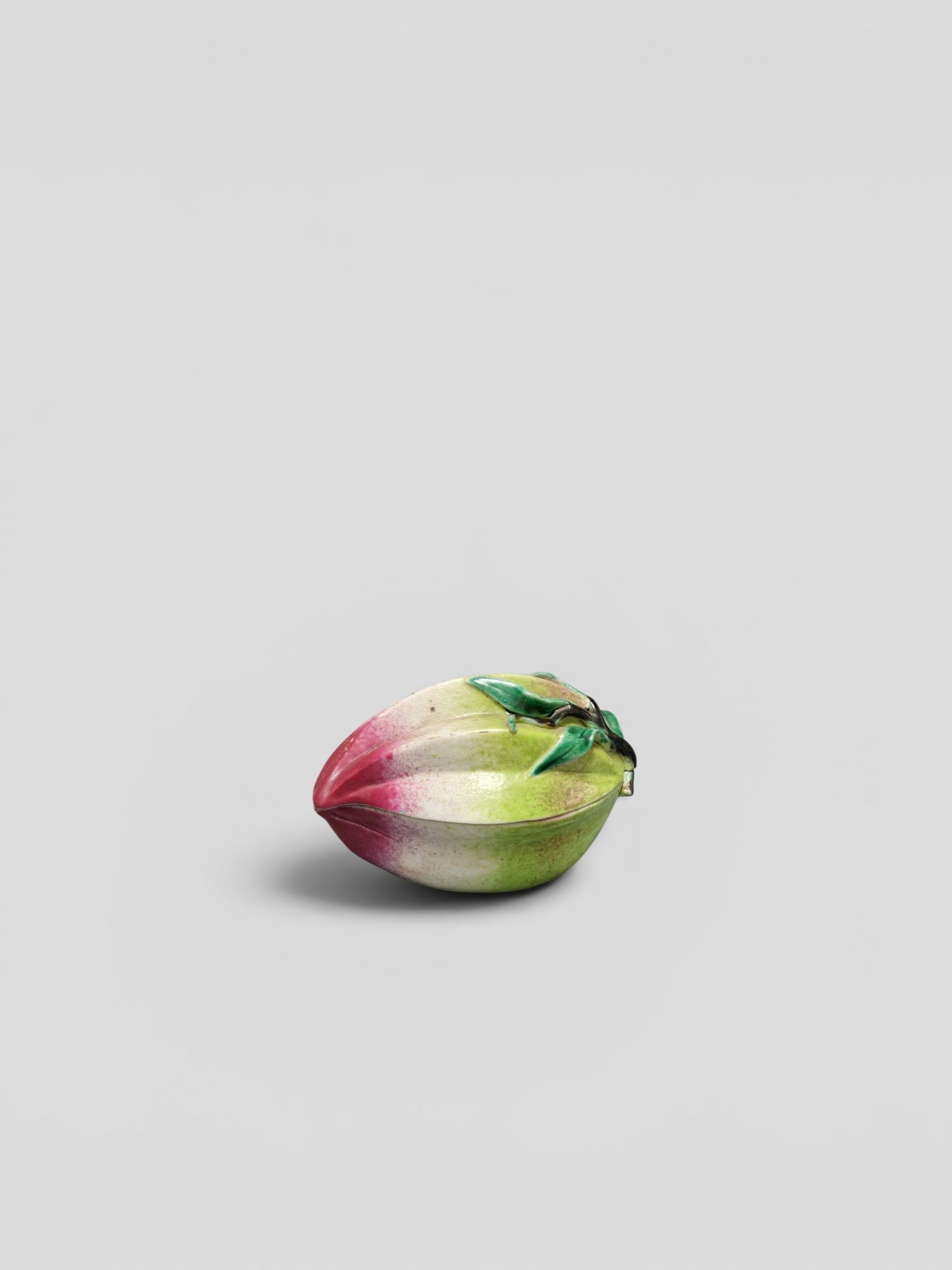 A Chinese famille rose porcelain peach-form covered box — Qing Dynasty, 19th Century