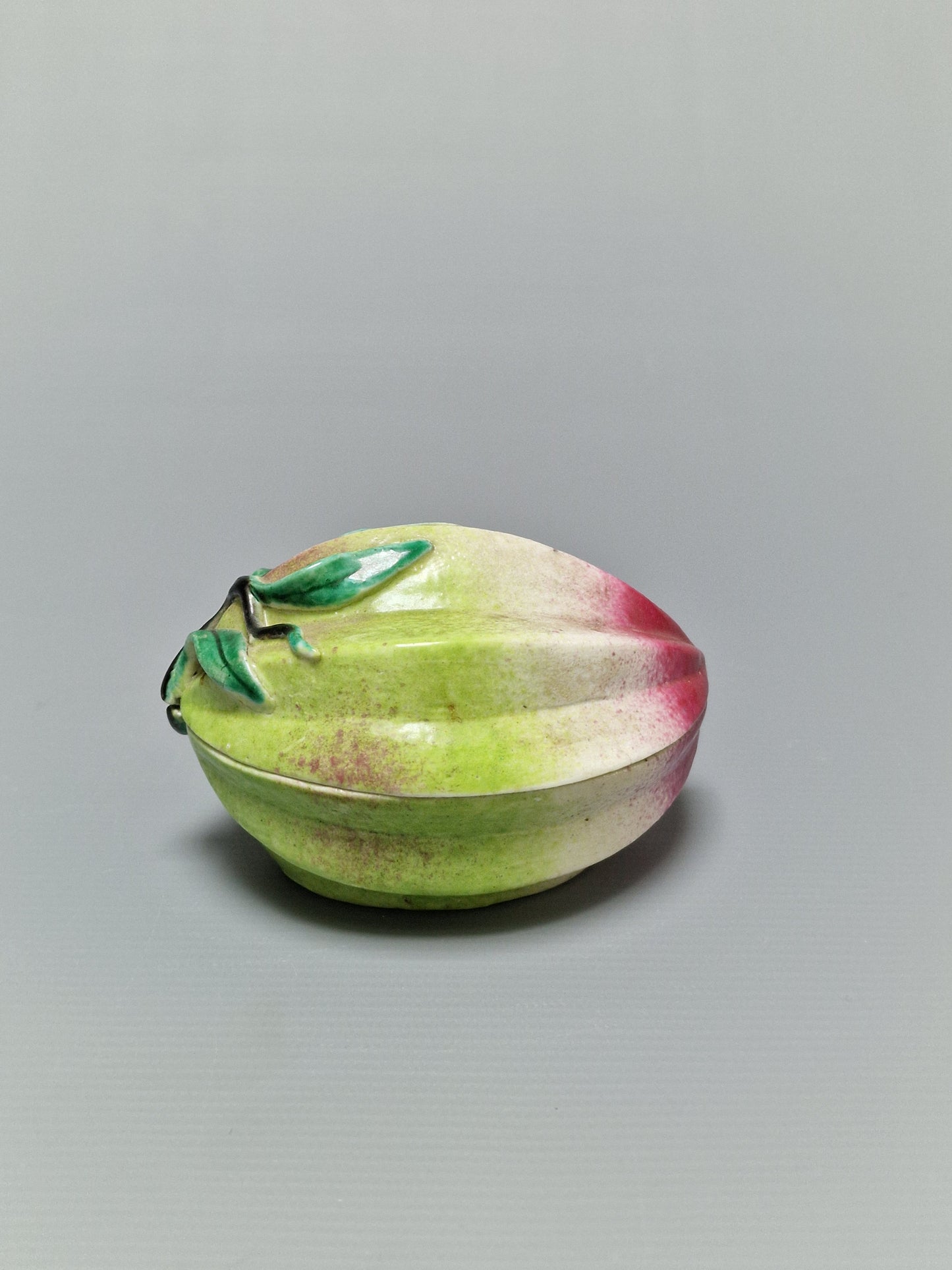 A Chinese famille rose porcelain peach-form covered box — Qing Dynasty, 19th Century