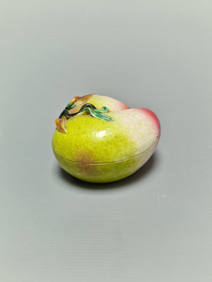A Chinese famille rose porcelain covered box in the form of a peach — Qing Dynasty, 19th century