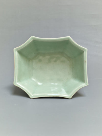 A Chinese octagonal famille rose celadon-ground 'Brocade Balls' offering bowl on a wooden stand, bearing a Daoguang mark, 19th century