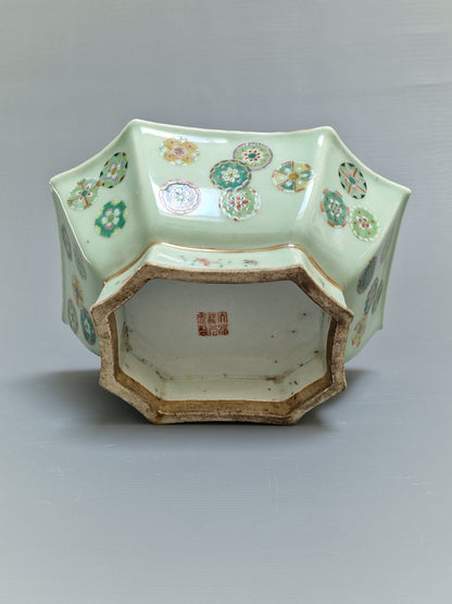 A Chinese octagonal famille rose celadon-ground 'Brocade Balls' offering bowl on a wooden stand, bearing a Daoguang mark, 19th century