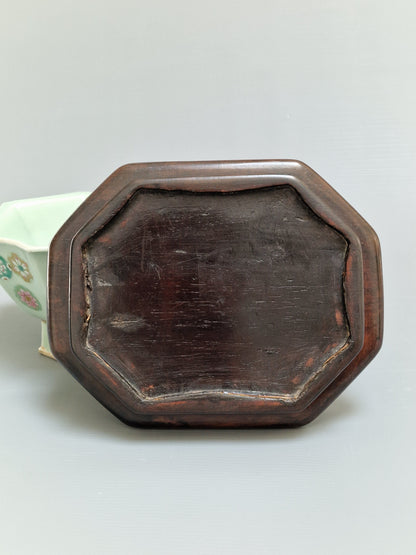 A Chinese octagonal famille rose celadon-ground 'Brocade Balls' offering bowl on a wooden stand, bearing a Daoguang mark, 19th century
