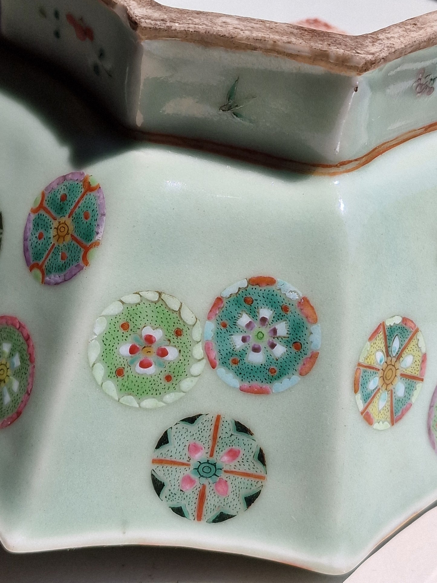 A Chinese octagonal famille rose celadon-ground 'Brocade Balls' offering bowl on a wooden stand, bearing a Daoguang mark, 19th century