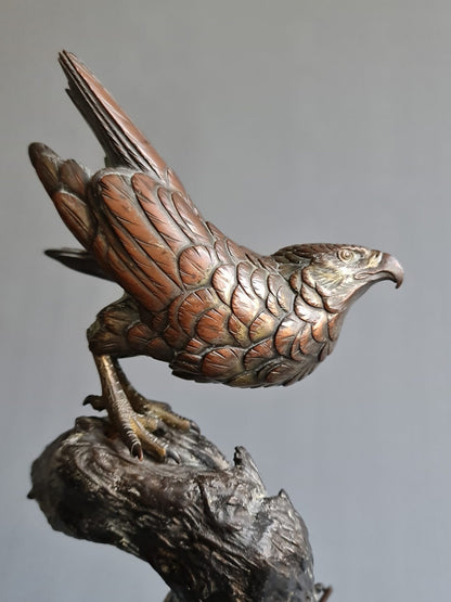 A large Japanese falcon perched on a branch, bronze sculpture, Meiji period (1868-1912)