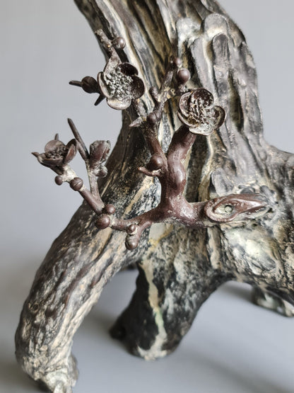 A large Japanese falcon perched on a branch, bronze sculpture, Meiji period (1868-1912)