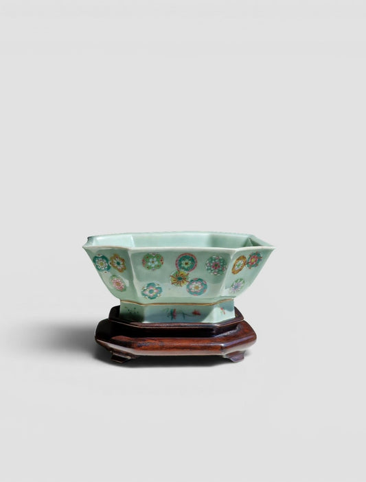 A Chinese octagonal famille rose celadon-ground 'Brocade Balls' offering bowl on a wooden stand, with a Daoguang mark, 19th century