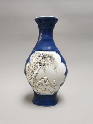 A rare Chinese vase shaped like bamboo and carved with drawings on both sides