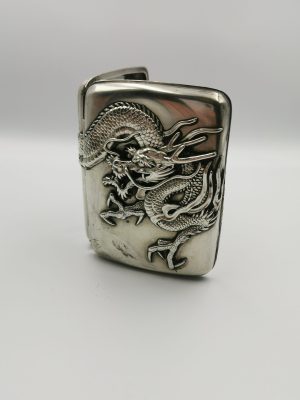 A Chinese silver cigarette case with dragon decoration from the late Qing dynasty
