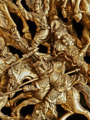 A Chinese Carved Deep Relief Gilt Wood Panel Depicting Warrior Scenes