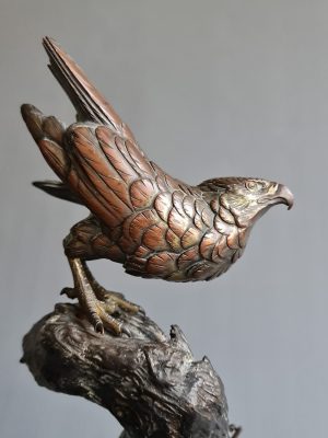 A large Japanese falcon perched on a branch, bronze sculpture (okimono), Meiji period (1868-1912)