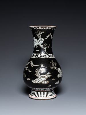 A Chinese black-ground vase decorated in grisaille with a figure on horseback with attendants, 19th century