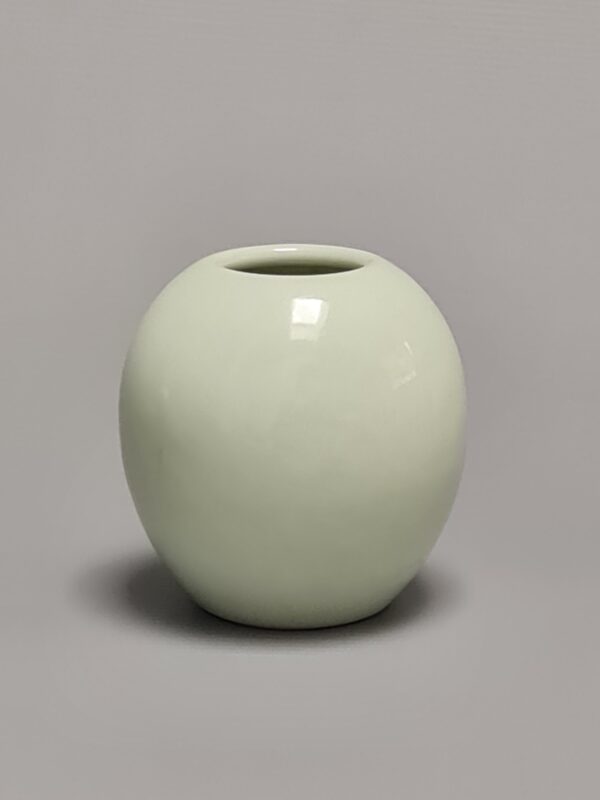 A Chinese pale green celadon water pot, Qianlong underglaze blue marked, early 19th century